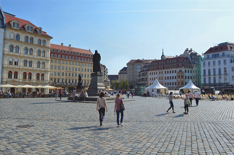 8 - Neumarkt Square in the historic Altstadt district of Dresden, with traditional cobblestone paving, reconstructed Baroque-style buildings, and the prominent bronze monument of Martin Luther
